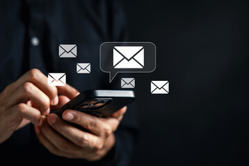 Hands using smartphone to send and read emails with envelope icons. Mobile communication