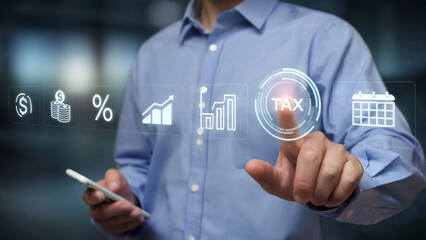 Man interacting with a futuristic digital interface selecting the tax icon on a screen with financial and calendar symbols