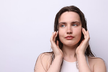 Fototapeta premium Beautiful woman with natural skin complexion on light grey background, closeup. Space for text