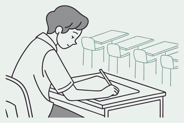 Focused male student taking test in classroom, ideal for education, exams, or academic success promotions.