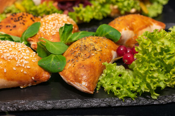 Plate of food with a variety of pastries and vegetables. The food looks delicious and inviting.