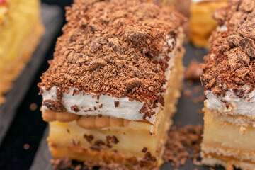 Dessert with a chocolate topping and a white filling. The dessert is cut into two pieces. Concept of indulgence and enjoyment, as the dessert is presented in a visually appealing manner.