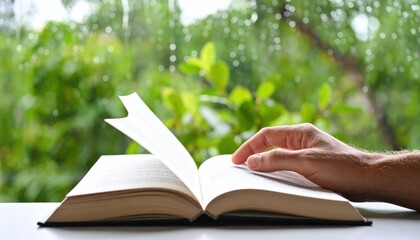 Open Book With Hand Reading In Front Of Window With Rainy Weather