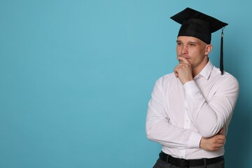 Thoughtful student after graduation on light blue background. Space for text