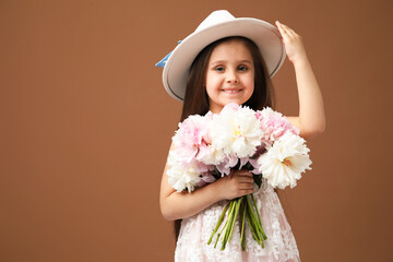Cute little girl with bouquet of beautiful peonies on brown background, space for text