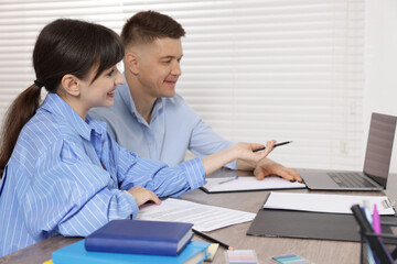 Consultant working with client at table in office. Business meeting