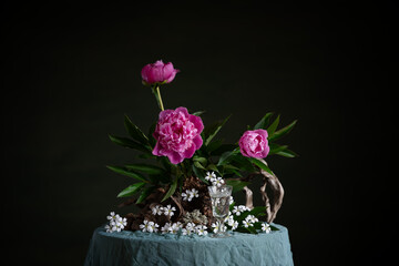 Graceful peonies, radiating elegance and tenderness, with branches and snags. A harmonious...