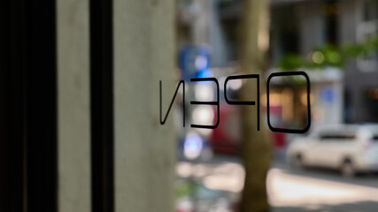Open sign in city storefront during daylight hours