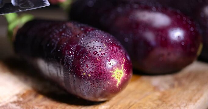 cut purple eggplant , sliced ripe eggplant on the table before cooking