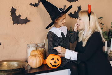 Mother and Daughter Preparing for Halloween Party at Home