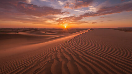 Fototapeta premium Golden sun descends upon the vast desert landscape, casting long shadows across the arid sand dunes
