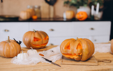 Preparing halloween pumpkins at home with spider decorations