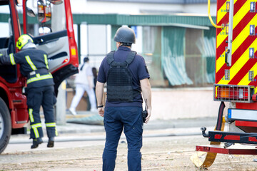 Firefighter and officer near emergency vehicle