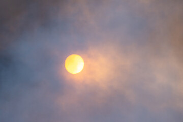 Orange sun in haze from smoky atmosphere