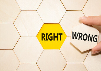 Right or Wrong symbol. Concept word Right or Wrong on wooden comb puzzle. Businessman hand....