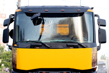 Yellow truck front with damaged windshield