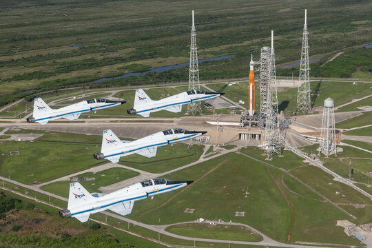 Four NASA T-38 Talon chase aircraft fly in formation over the Space Launch System (SLS) rocket on Launch Pad 39B at Kennedy Space Center for pre-launch operations. August 2022. Image courtesy of NASA