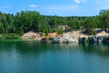 The abandoned Korostyshiv quarry, with its deep blue waters and rugged cliffs, has become a scenic spot for recreation, fishing, and swimming.