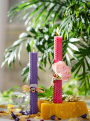 Beautiful pink and purple handmade beeswax candles. Candles for Love, femininity and sexuality.  Aromatherapy. Wax candles. Selective focus