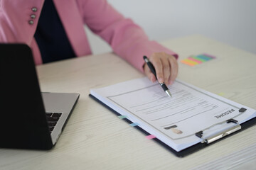 A young asian female Head of HR is reading resume and making a call for the recruitment interview process with the candidate who has been selected to work in the company, employment and HR concept.