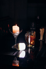 Power outage. Romance. A candle and a battery-powered lamp are on the table.