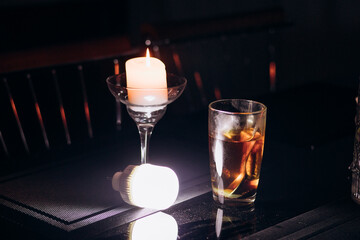 Power outage. Romance. A candle and a battery-powered lamp are on the table.