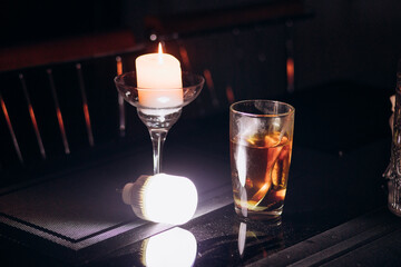 Power outage. Romance. A candle and a battery-powered lamp are on the table.