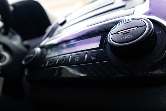 Air conditioning and heater control panel in a car with carbon fiber trim