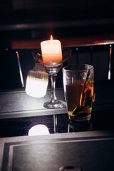 Power outage. Romance. A candle and a battery-powered lamp are on the table.