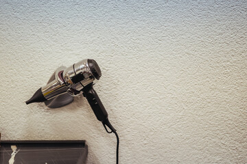 Professional hair dryer mounted on a salon wall, ready for use in a modern barbershop or hair...