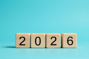 Two wooden blocks with numbers 2020 displayed prominently..New Year 2026.