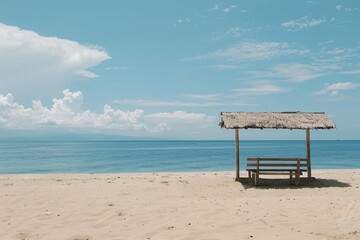 Fototapeta premium A serene beach scene featuring a wooden hut and a tranquil ocean under a bright blue sky.