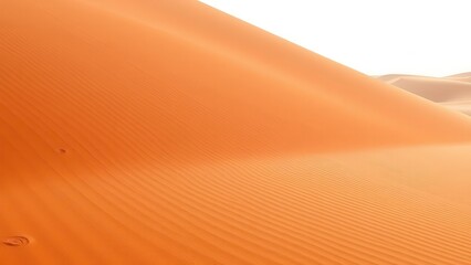 Smooth orange sand dune with fine wind patterns
