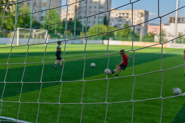 Children enjoy kicking a soccer ball on a grassy field