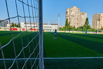 The view through a soccer goal net at a local field