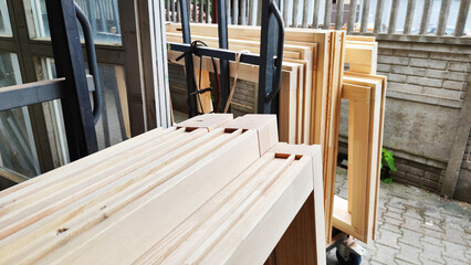 Pine wooden frames for windows, doors, production warehouse in the carpentry workshop. Production...