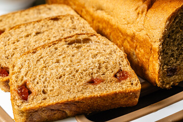 horizontal close-up photo of traditional artisan whole wheat sliced bread with guava jam next to a cup of coffee in a healthy vegetarian restaurant in Colombia