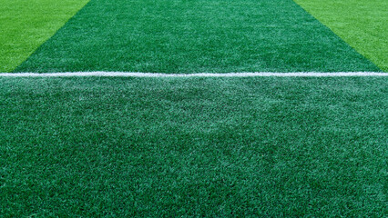 Close up of bright green artificial turf and crisp white markings