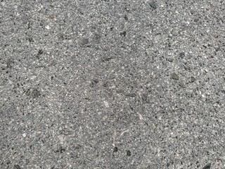 Texture of grey, dry road asphalt.
