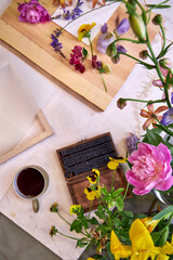 Creative flat lay of botanical printmaking with colorful flower petals, frame, coffee cup, and...