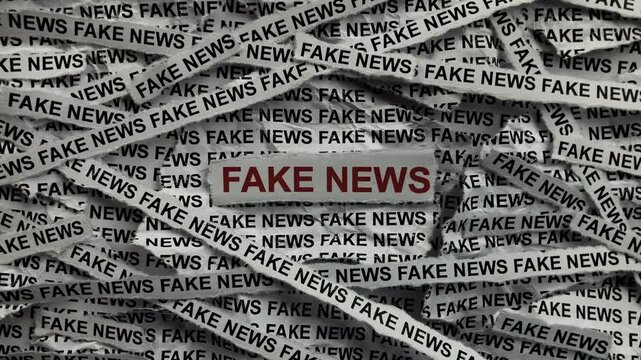 Strips of newspaper with the words Fake News typed on them. Close up.