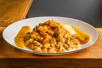 Horizontal photo of vegetarian lasagna with slices of ripe banana in a healthy vegetarian restaurant in Colombia