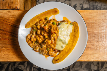 Horizontal cential shot of vegetarian lasagna with slices of ripe banana in a healthy vegetarian restaurant in Colombia