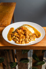 Vertical photo of vegetarian lasagna with slices of ripe banana in a healthy vegetarian restaurant in Colombia