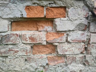 Texture - Old deteriorated brick house facade