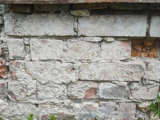 Texture - Old deteriorated brick house facade