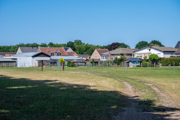 Dried out meadow, backyards with sheds and houses in Oosterloo, Geel, Belgium