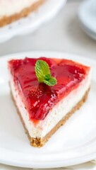 Strawberry Cheesecake Slice with Mint Garnish on White Plate