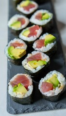 Tuna Avocado Sushi Rolls on Dark Slate Plate rice seaweed