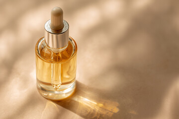 Naklejka premium glass dropper bottle with golden serum on beige background, natural skincare, beauty product, soft sunlight, minimalistic style, wellness concept